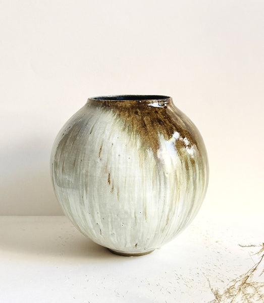 Grand vase rond tourné en grès gris émaillé en couleur blanc brillant et coulures à effets doré